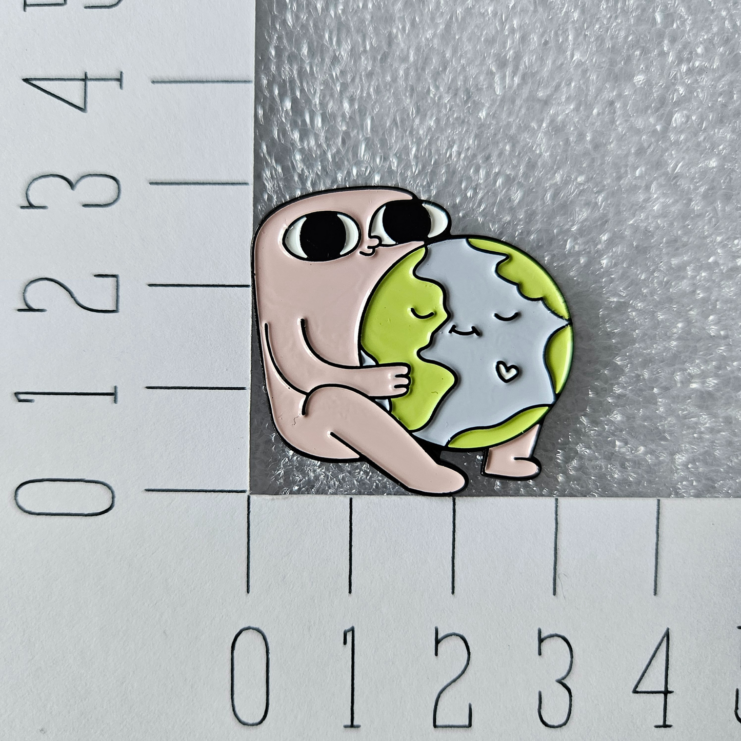 Enamel pin - Reus met wereldbol - Hobby en meer