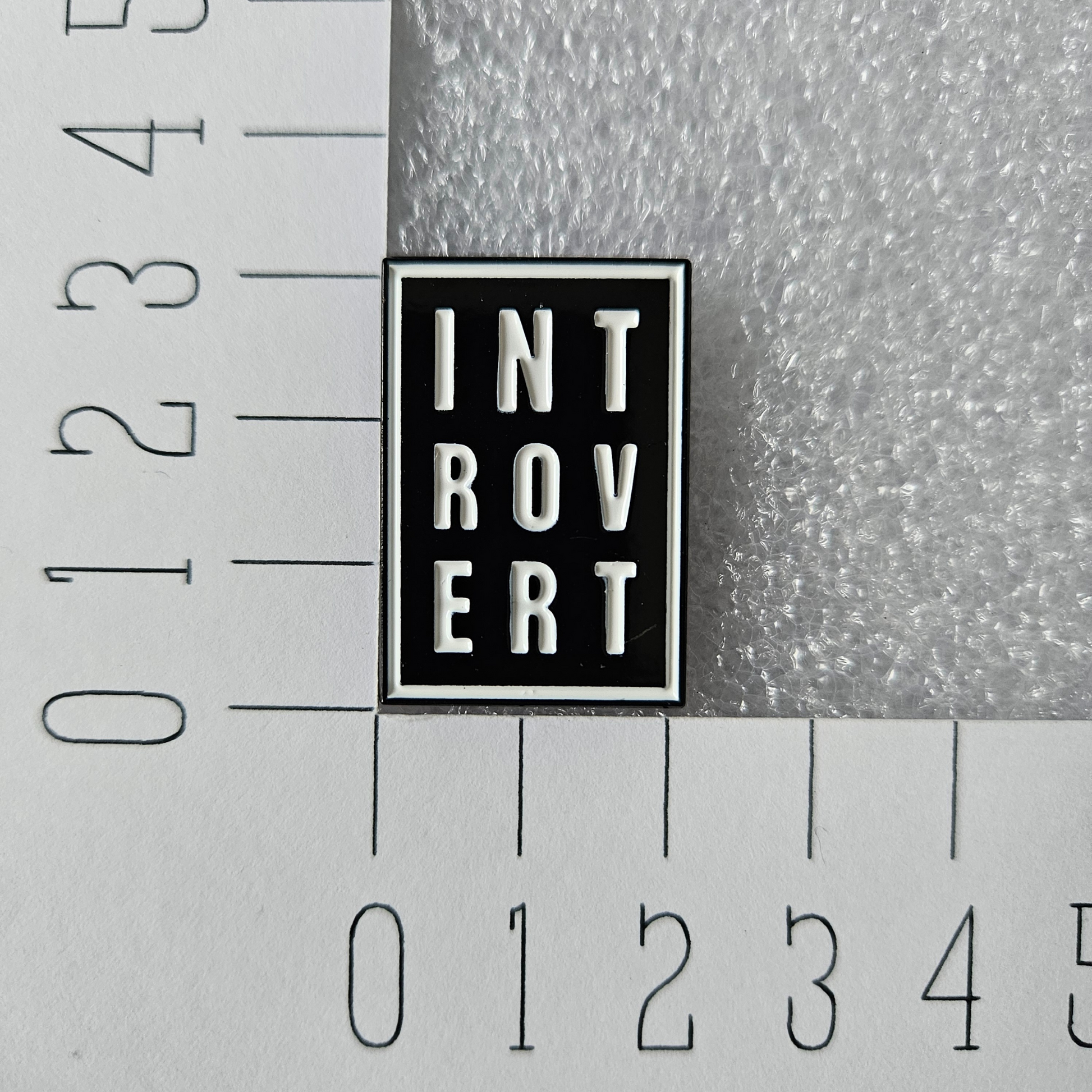 Introvert enamel pin